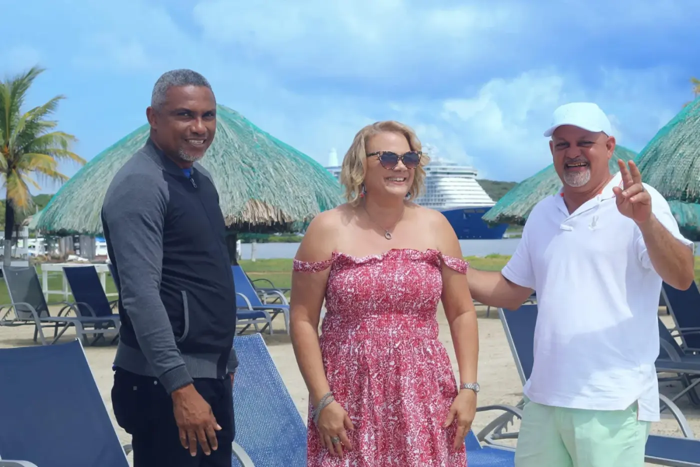 Travelers at beach club shore excursion with cruise ship in background
