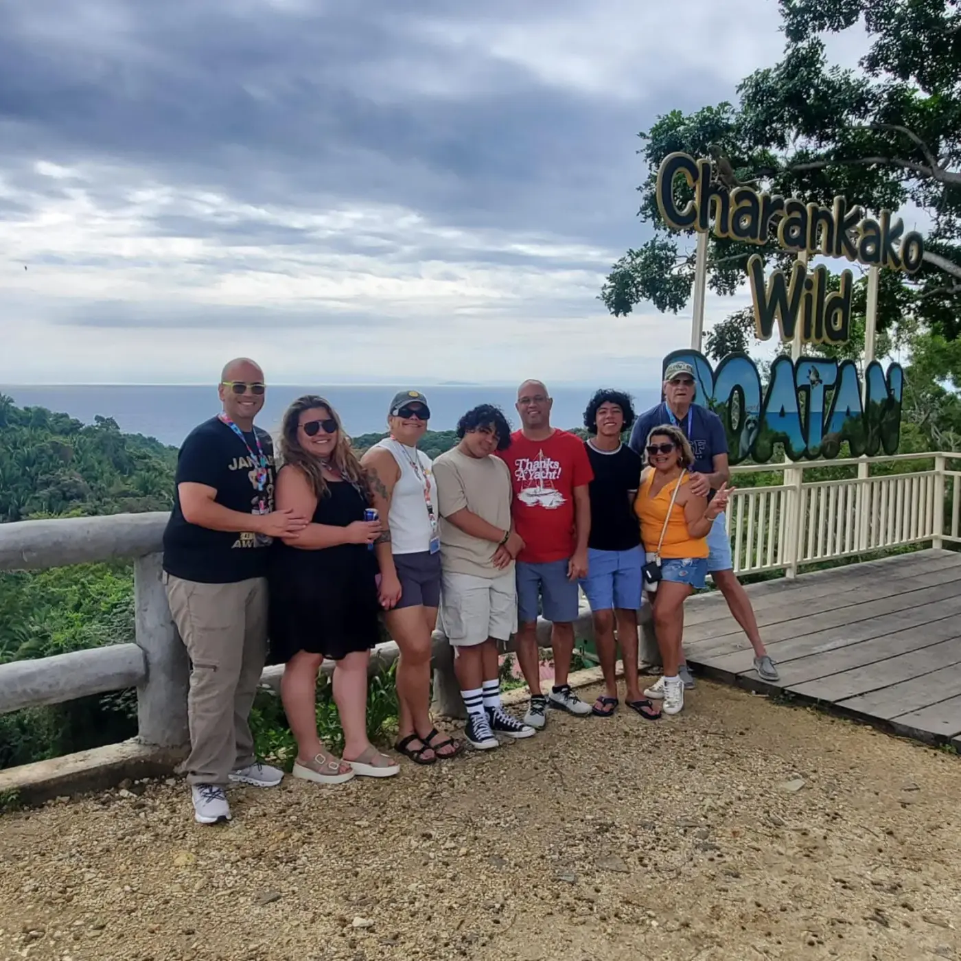 Group at Charankako Wild Roatán scenic viewpoint overlooking hills and sea