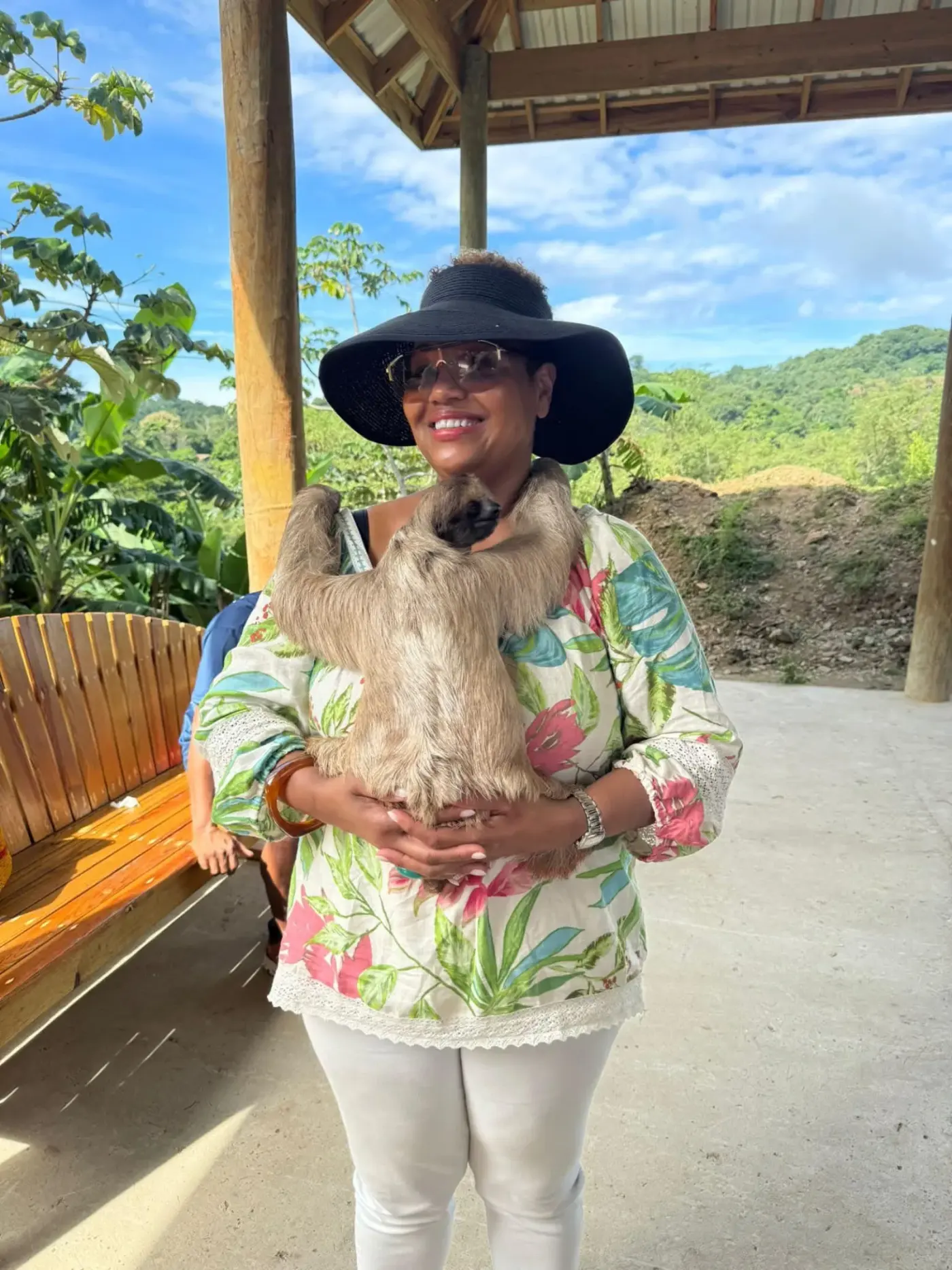 Woman holding a sloth during wildlife encounter tour